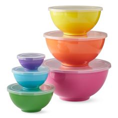 four bowls stacked on top of each other with lids in different colors and sizes,