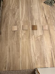 wood flooring being laid out on top of a wooden floor in a living room