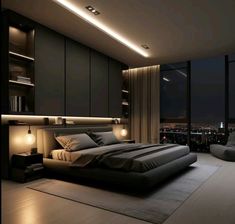 a large bed sitting in the middle of a bedroom next to a window with city lights on it