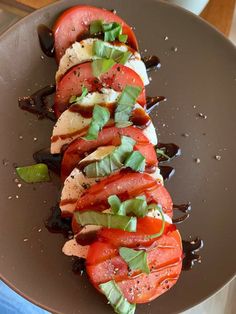 a brown plate topped with sliced tomatoes and meat