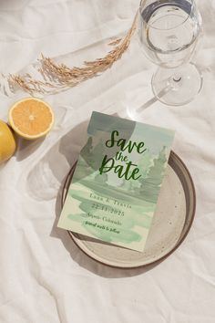 a plate with an orange next to some wine glasses