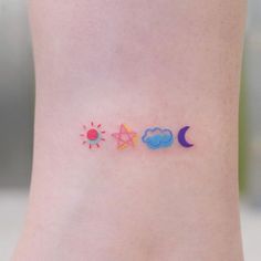 a woman's ankle with three small tattoos on it, including the sun and moon