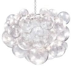 a white chandelier with clear balls hanging from it's center chain, on a white background