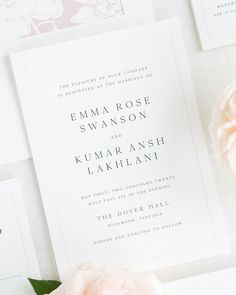 the wedding stationery is laid out on top of each other, with pink flowers