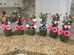 three pineapples decorated with sunglasses and flowers