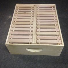 a wooden box sitting on top of a carpeted floor