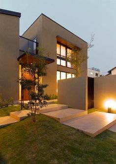 an exterior view of a modern home with steps leading up to the front door