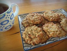 some oatmeal cookies on a plate next to a cup of coffee