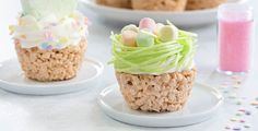 three cupcakes decorated with easter eggs and candy