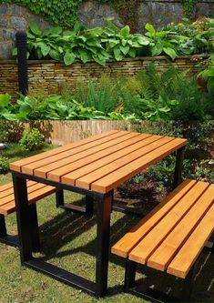 a wooden table and bench in the grass