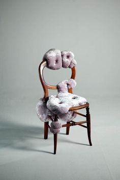 a stuffed animal sitting on top of a wooden chair