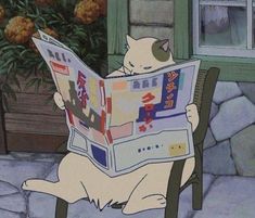 a cat sitting in a chair reading a newspaper