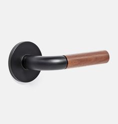 a black and wood handle on a white wall