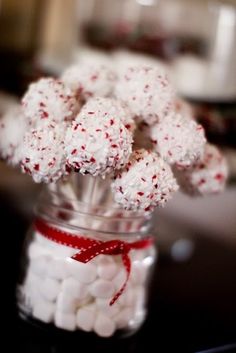 a jar filled with marshmallows on top of a table