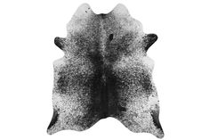 a black and white photo of a cow skin rug