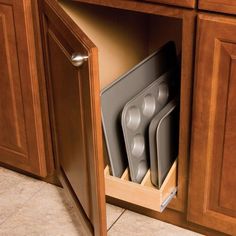 an open cabinet with silverware in it