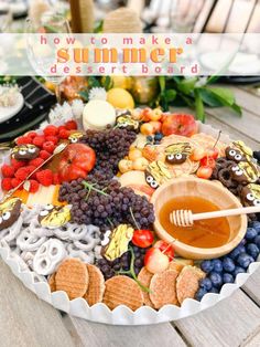 a platter filled with fruit, crackers and honey on top of a wooden table