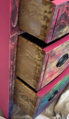 the drawers are painted pink and brown