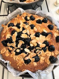 two pies with blueberries and almonds on top