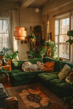 a living room filled with lots of green furniture and plants on the windows sill