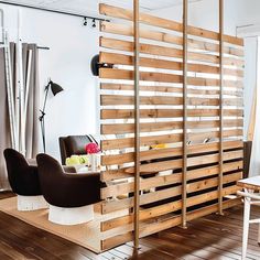 a living room filled with furniture and wooden slats