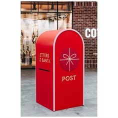 a red mailbox sitting in front of a brick building with the words letters santa written on it