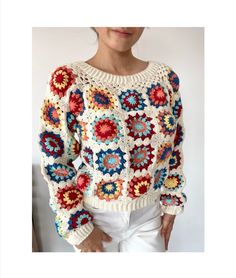 a woman is wearing a crocheted sweater with flowers on the front and sides