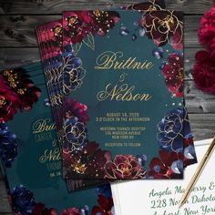 wedding stationery with flowers and gold foil on it, along with an envelope for the couple's guests