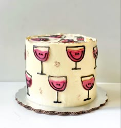 a decorated cake with wine glasses on it