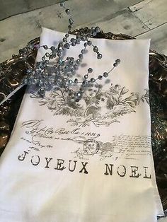 a white towel with the words jovex noel on it sitting in a metal tray