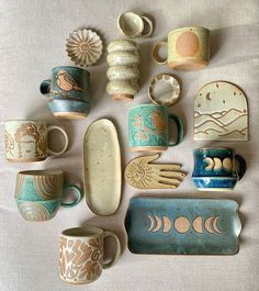 there are many ceramic items on the table together, such as cups and saucers