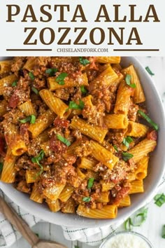 pasta alla zozzona in a white bowl with parmesan cheese on the side