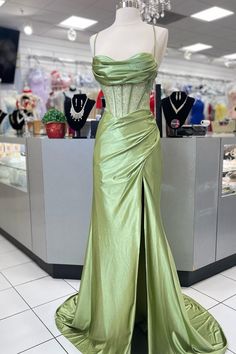 Constructed with a lustrous satin fabric, this dress features a complementary sage green hue and a structured corset bodice with delicate spaghetti straps and a sheer waistline. The mermaid silhouette is enhanced with a side slit for ease of movement, while the lace-up back ensures a perfect fit. Complete with a built-in bra and designed to fall to a full length for a stunning formal look. SKU: 3574 Satin material Sage green color Corset bodice with spaghetti straps and sheer waistline Side slit Beaded Corset, Lavender Prom Dresses, Prom Dress Trends, Structured Corset, Navy Blue Prom Dresses, Prom Dress Shoes, Black Homecoming Dress, White Homecoming Dresses, Royal Blue Prom Dresses