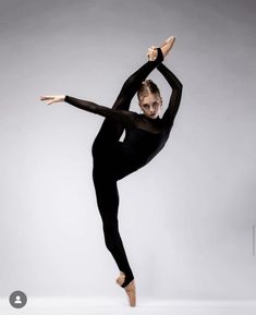 a woman in black leotard doing a dance pose