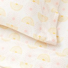 an image of a bed sheet set with yellow and pink designs