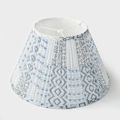 a blue and white lamp shade on a white background