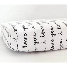 a black and white pillow with writing on it