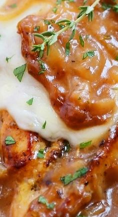 a close up of food on a plate with gravy and parmesan cheese