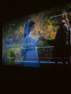 the screen is showing an image of two women in historical dress, one holding a flower