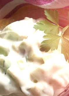 a small bowl filled with food and garnished with green leaf sprigs