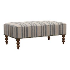 an upholstered bench with wooden legs and striped fabric