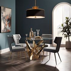 a modern dining room with blue walls and wood flooring, including a round glass table surrounded by grey upholstered chairs