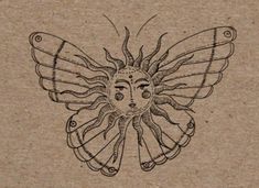 a drawing of a butterfly on top of a piece of paper with an image of a woman's face