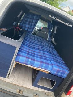 the bed in the back of a van is folded up and ready to be loaded