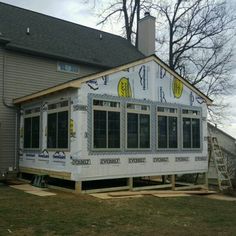 a house being built with windows and siding