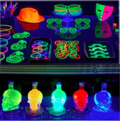 several bottles with neon lights and glasses on them