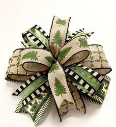 a green and white bow with trees on it