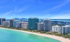 an aerial view of the beach and city skyline in miami, florida with clear blue water