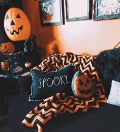 a bed with halloween decorations on it and a spooky pillow in the corner