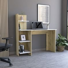 an office desk with bookshelf and computer monitor